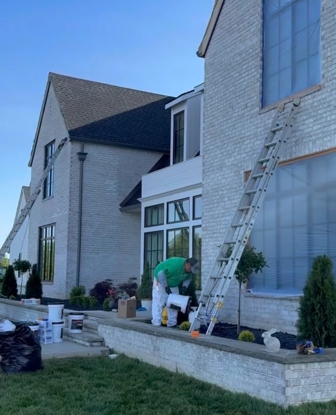 Man painting ceiling of residential home 